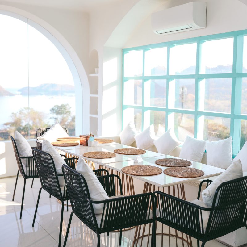 a dining area with a large round window